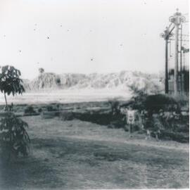 Child standing near Gas Works, Boundary st with Cyanide Heaps in background