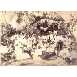 Large group of men and women in a bush setting