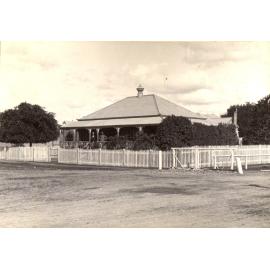 Two men on verandah of house