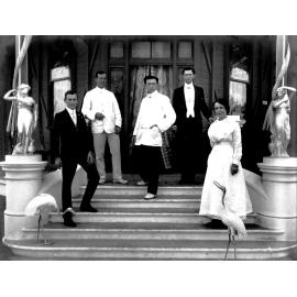 Richard Hosking, dentist, on front stairs of surgery with staff