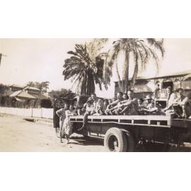 People on the back of a Civil Construction Corps Truck in Ryan Street