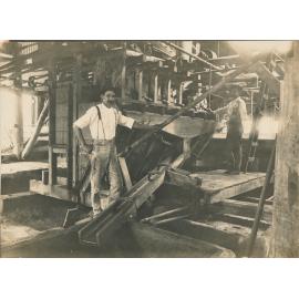 Three men standing in Liontown Oil Flotation Plant