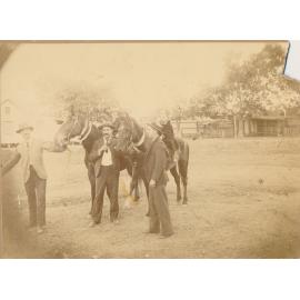 Children riding horses “Kimberley” and “Pebble” being led by men