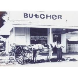 Mrs Patterson outside Doug Russell’s Butcher Shop, Queenton, 1972