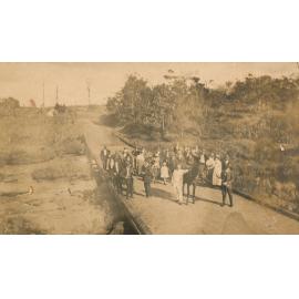 Group of people standing on a road bridge
