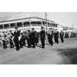 Excelsior Band marching past the Excelsior Hotel