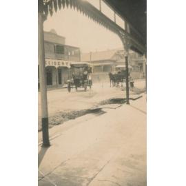 Motor Car Outside Ben Toll’s Building, Gill Street With Horse Drawn Vehicle in Background