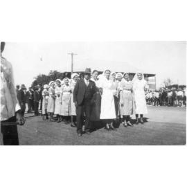 Jupiter Mosman with a group of nurses outside the hospital in Gill Street prior to the TPA New Years Day Sports procession, January 1941
