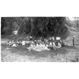 Group of People at a Picnic at River