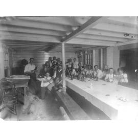 Group of Men Celebrating and Drinking in a Basement Room
