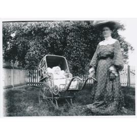 Mrs Wooster with baby in Pram in Garden