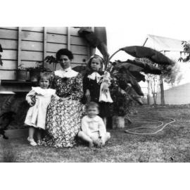 Harriet Wooster with children Edna, Horace and Norma in Backyard?