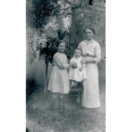 Unknown Woman with children Edna, and Norma Wooster in Backyard