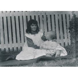Girl and baby sitting on blanket in garden at Wooster’s Mary St residence