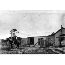 Three boys on horseback in front of Unknown House in the bush