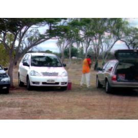 Player standing between cars at the 2003 Goldfield Ashes